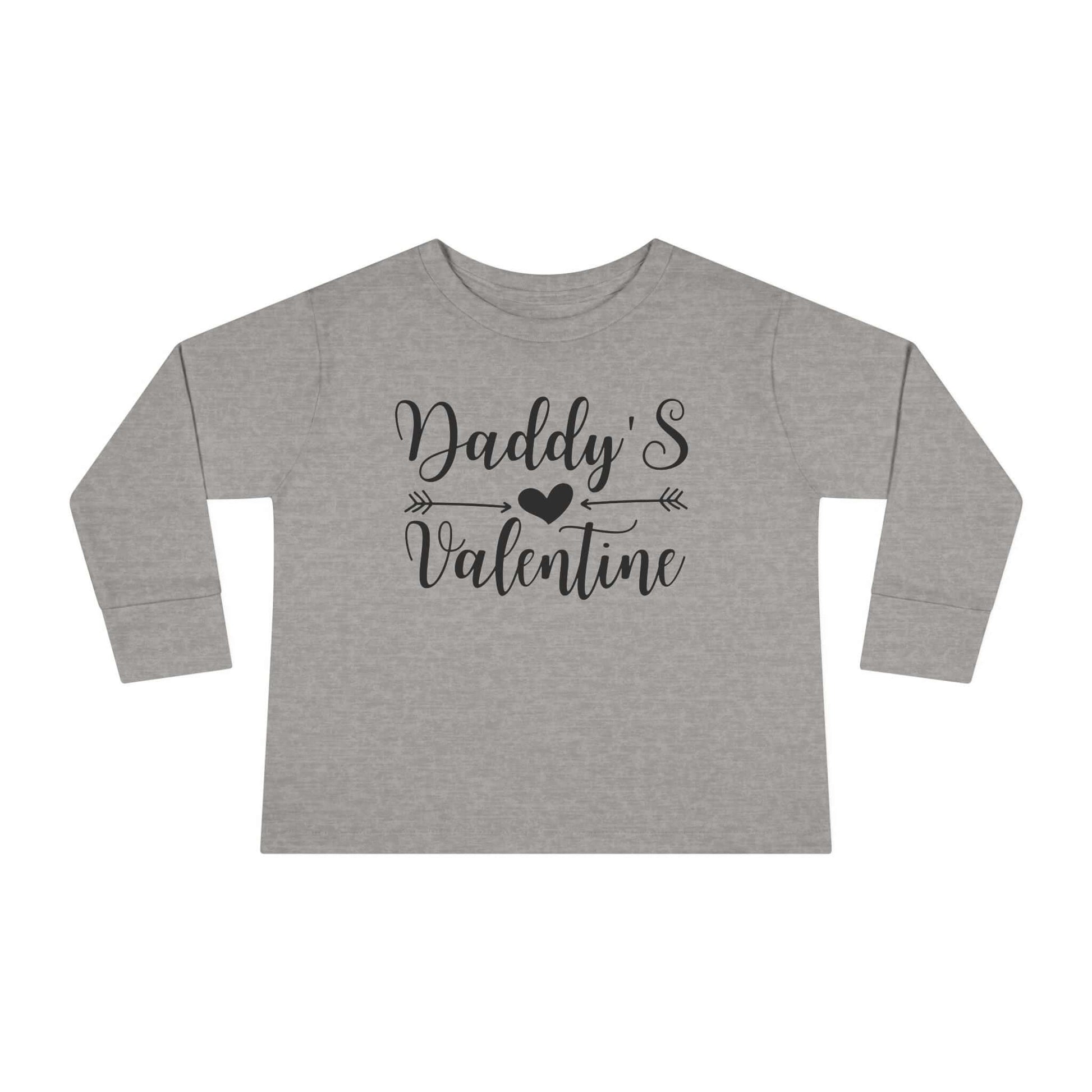 Daddy's Valentine Toddler long sleeve tee with hand-lettered design and heart on grey background.