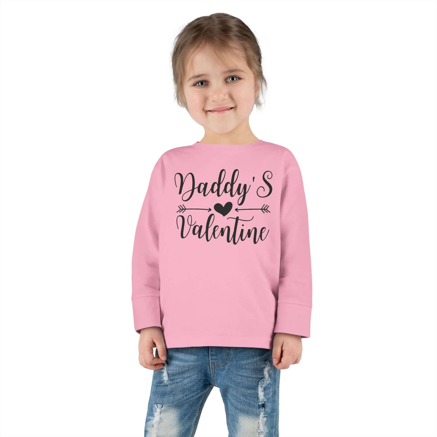 Toddler wearing a pink long sleeve tee with the text 'Daddy's Valentine' in hand-lettered script.