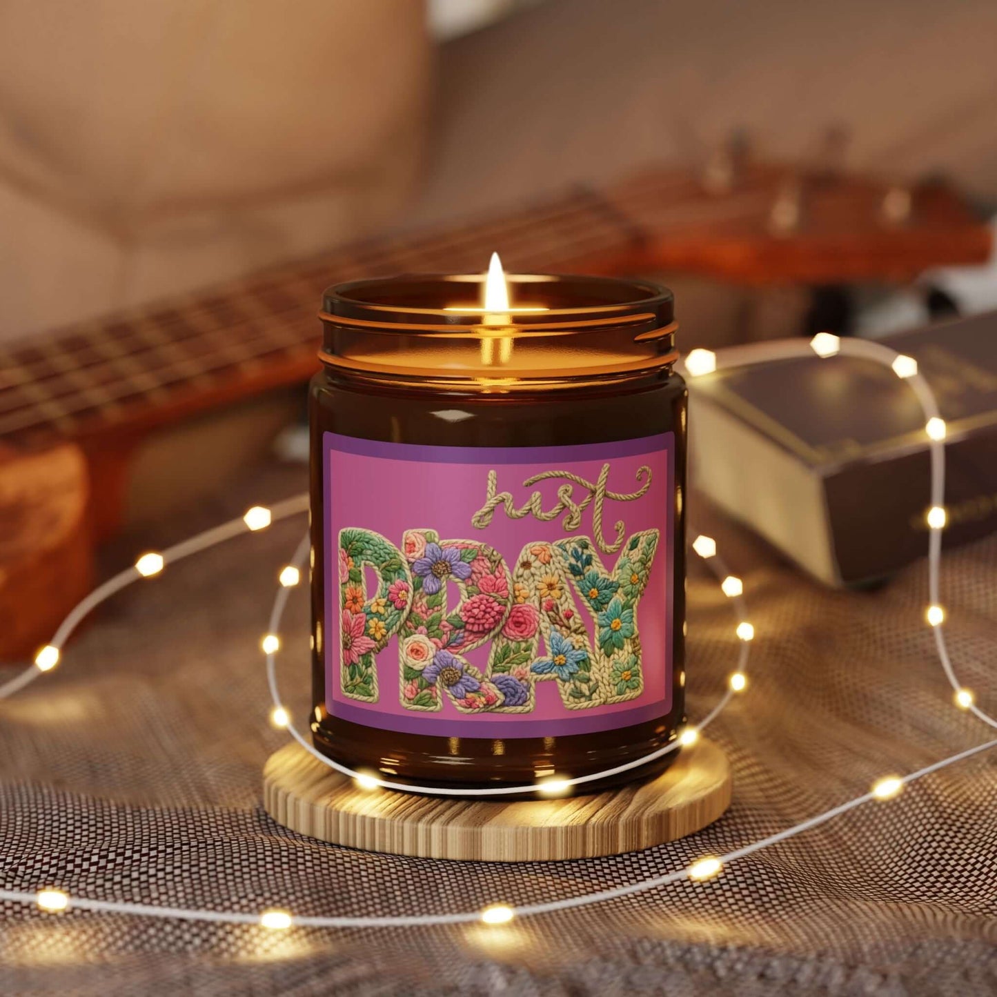 Just Pray Vegan Soy Candle featuring a warm amber glow and floral lettering on a cozy backdrop.