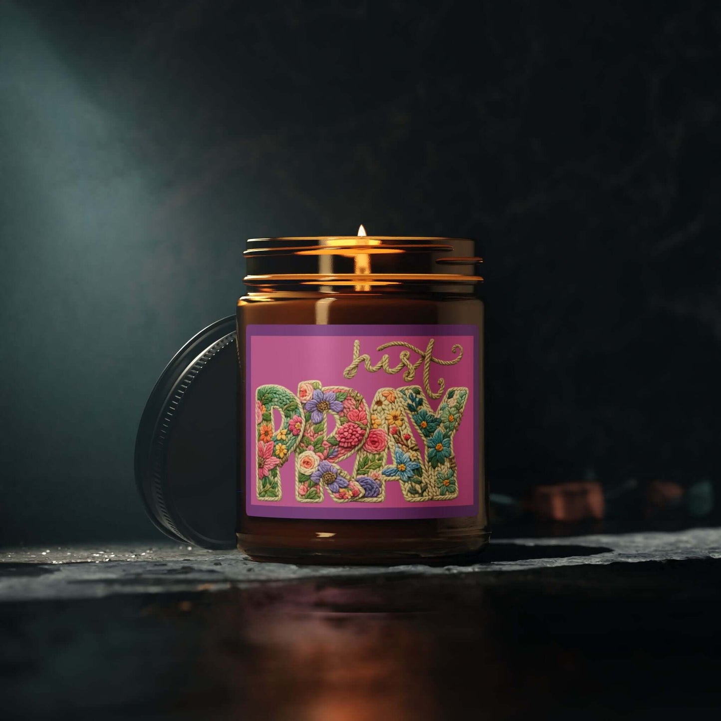 Just Pray Vegan Soy Candle in an amber jar with colorful label design, perfect for creating a calming atmosphere.