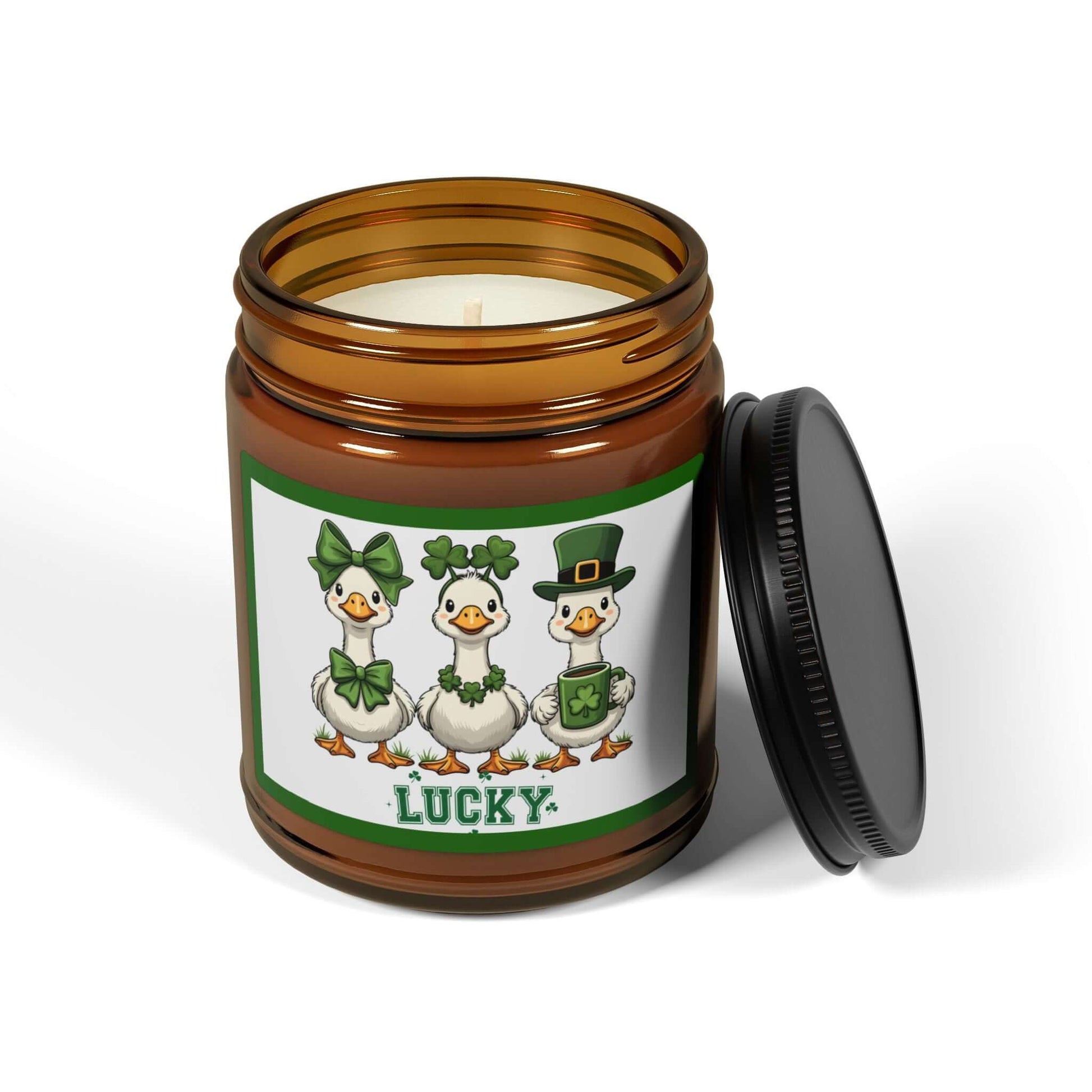Lucky Ducks Vegan Soy Candle in amber jar with playful St. Patrick's Day design featuring three lucky ducks.
