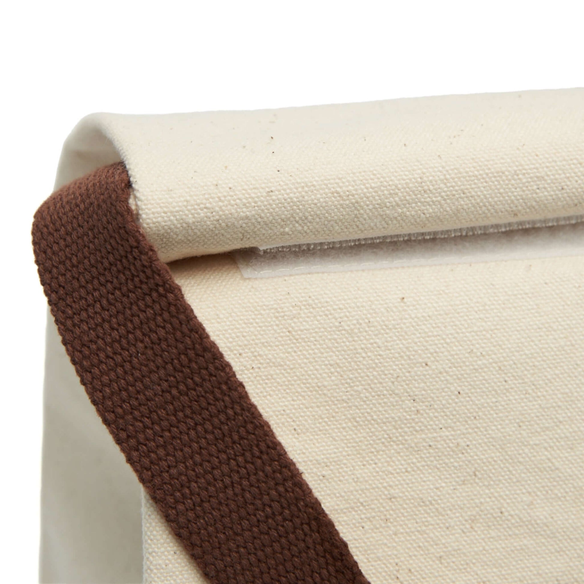 Close-up of Simply Cute Kittens canvas lunch bag showing roll-top closure and brown strap.